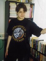 The Convention t-shirt is modelled by Karen Kruzycka. Ms. Kruzycka's hobbies include drinking, laughing uproariously and causing nearby males to drool uncontrollably. Her favourite colour is black, and she says she'd like to 'help make the world a more dangerous place'.